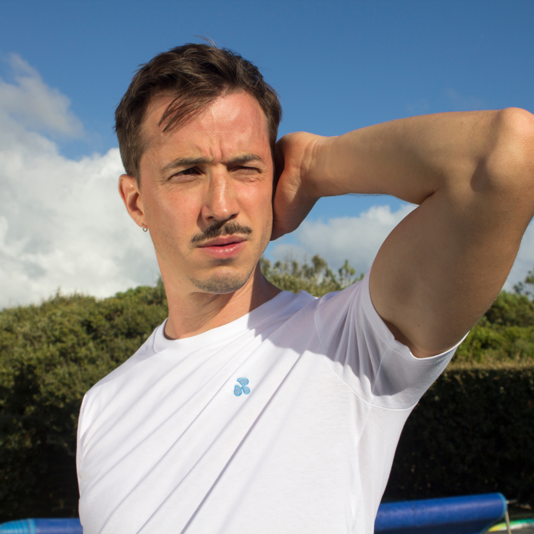 Out Now! model wearing a white t-shirt with a drops pattern, designed as an icebreaker for the LGBTQ+ community.