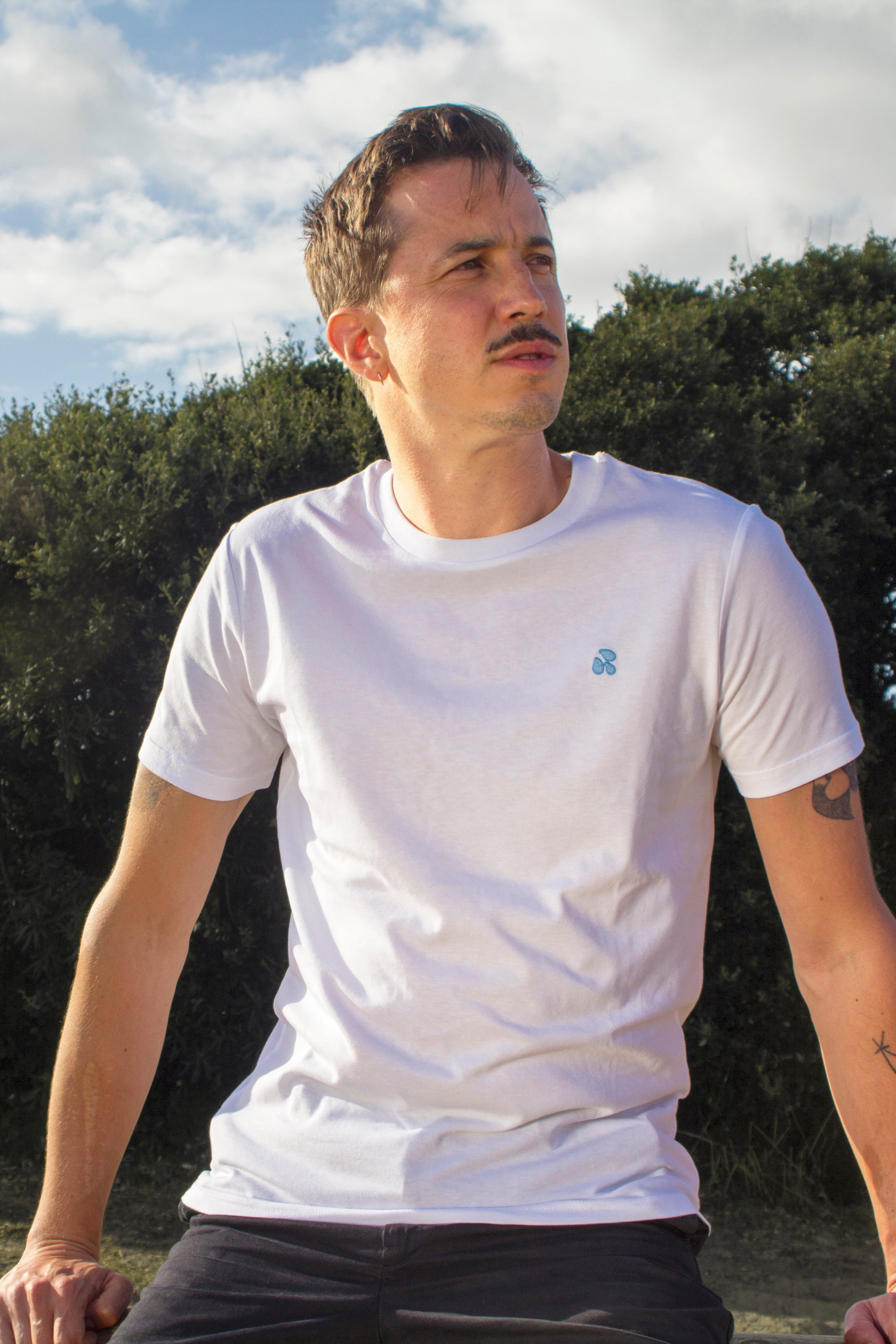 White t-shirt with drops pattern worn by an Out Now! model, great for sparking conversations in the gay community.