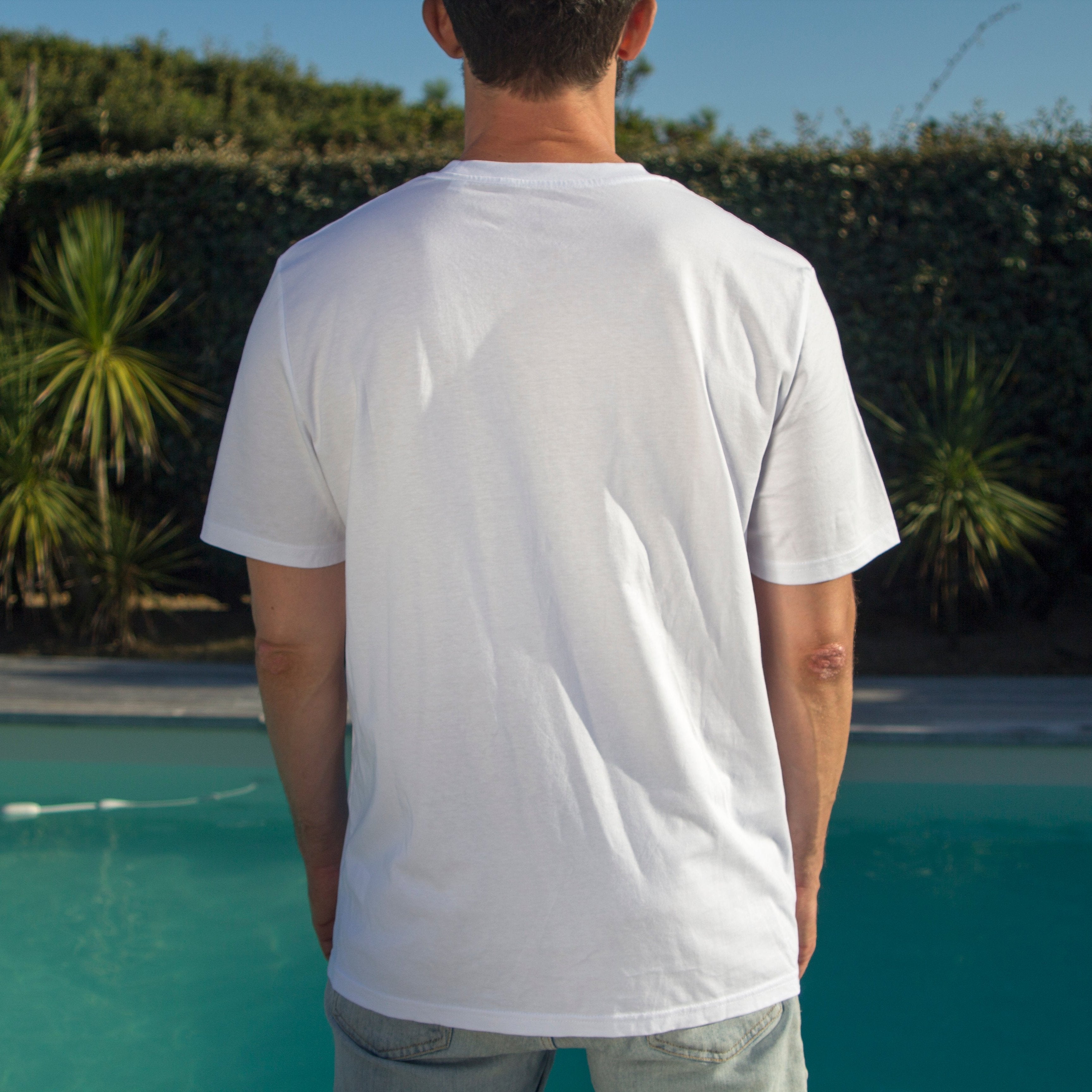 Back view of an Out Now! white "eggplant extravaganza" t-shirt with no pattern on the back, offering a clean and minimalist look.