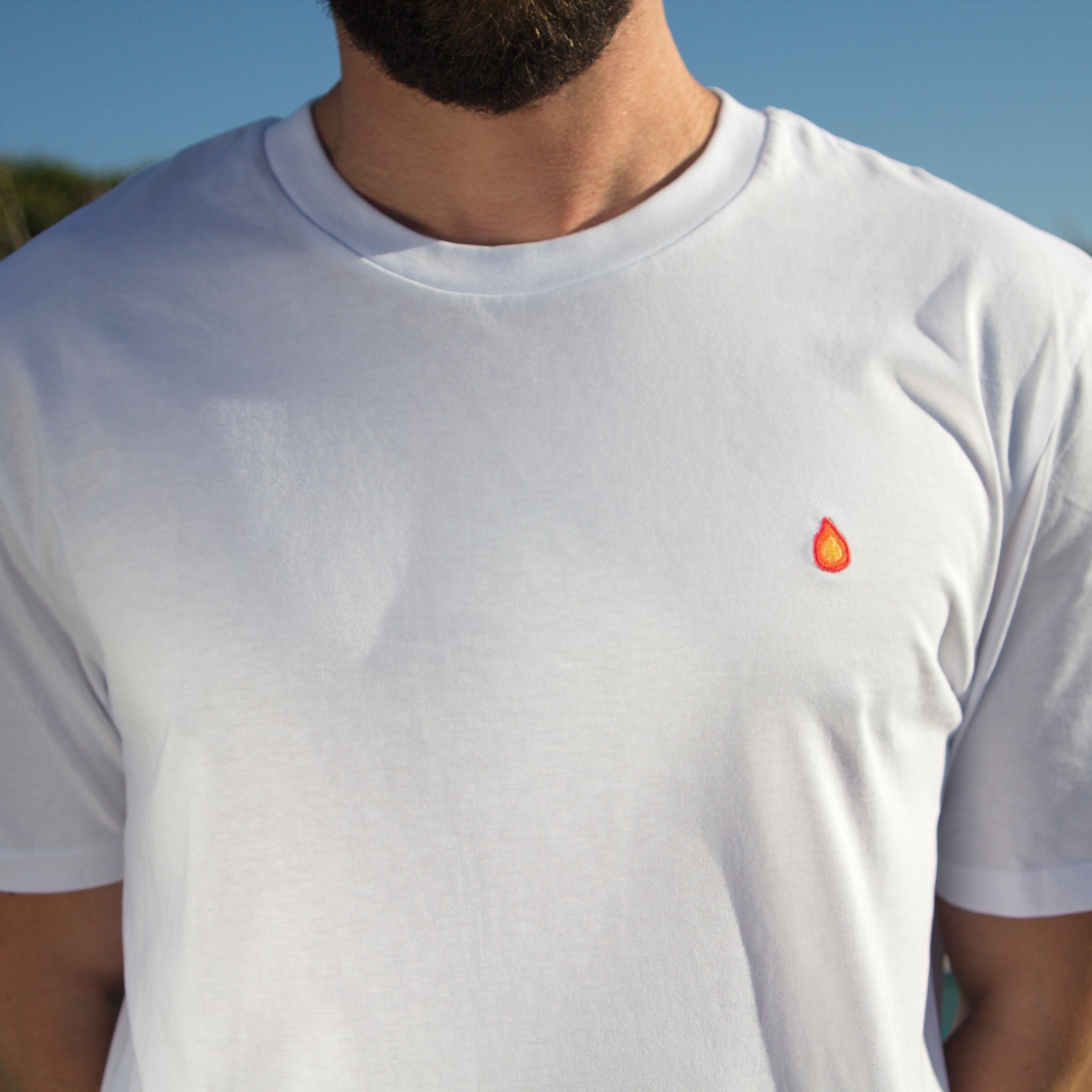 Close-up of the chest on an Out Now! t-shirt, highlighting the flame pattern placement.