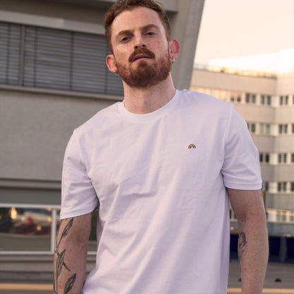 White t-shirt with rainbow pattern worn by an Out Now! model, great for sparking conversations in the gay community.