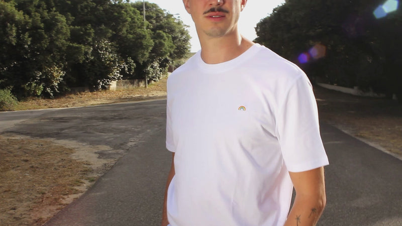 7-second video zooming in on the rainbow pattern of an Out Now! t-shirt worn by a model, highlighting the vibrant LGBTQ+ pride design.